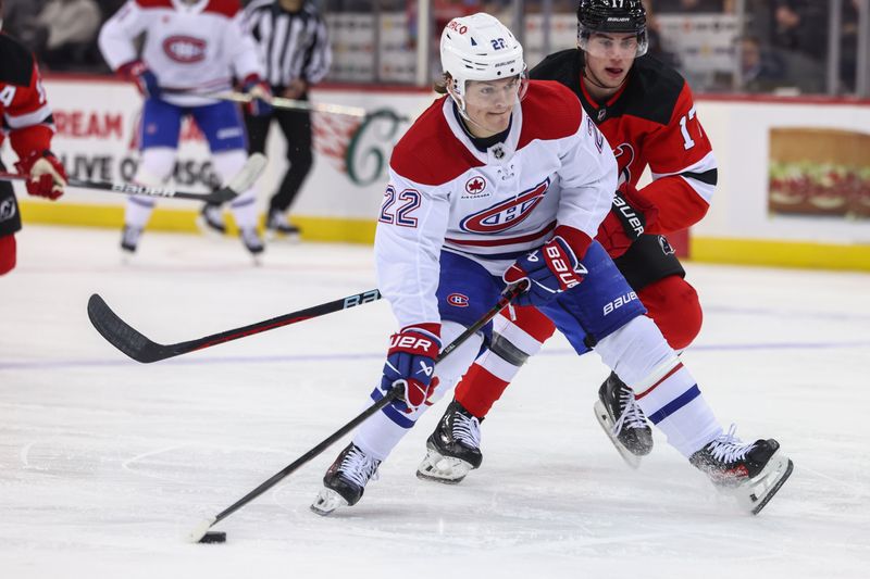 Jan 17, 2024; Newark, New Jersey, USA; Montreal Canadiens right wing Cole Caufield (22) skates with the puck while being defended by New Jersey Devils defenseman Simon Nemec (17) during the first period at Prudential Center. Mandatory Credit: Ed Mulholland-USA TODAY Sports