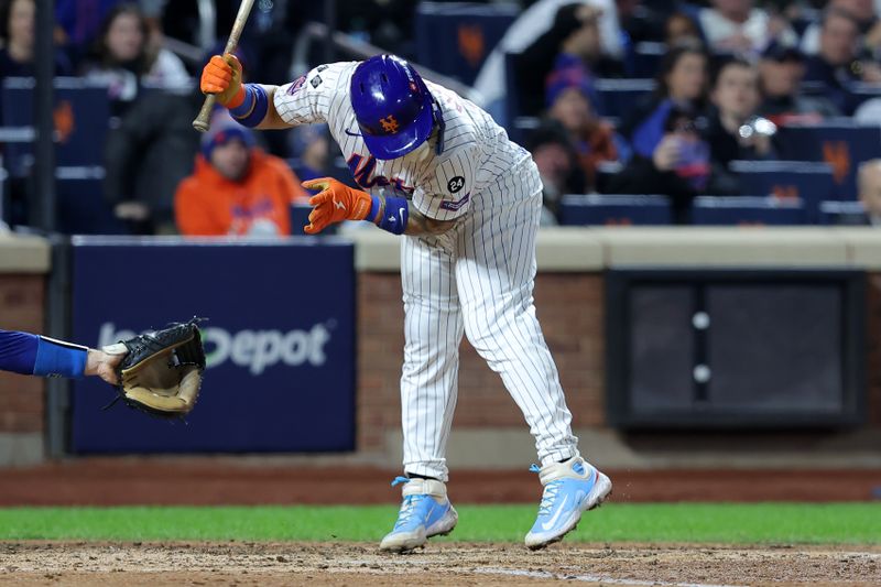 Oct 17, 2024; New York City, New York, USA; New York Mets catcher Francisco Alvarez (4) is hit by a pitch against the Los Angeles Dodgers in the fifth inning during game four of the NLCS for the 2024 MLB playoffs at Citi Field. Mandatory Credit: Brad Penner-Imagn Images