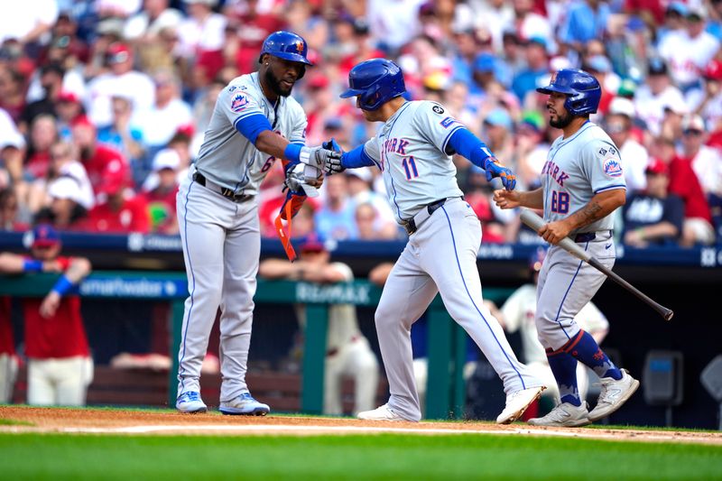 Sep 14, 2024; Philadelphia, Pennsylvania, USA; New York Mets second baseman Jose Iglesias (11) scores a run on New York Mets right fielder Starling Marte (6) bases loaded walk against the Philadelphia Phillies during the first inning at Citizens Bank Park. Mandatory Credit: Gregory Fisher-Imagn Images