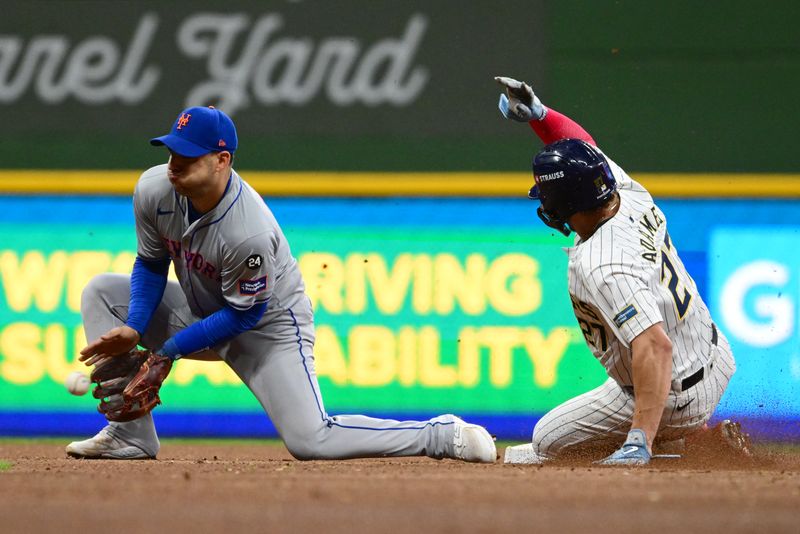 Oct 3, 2024; Milwaukee, Wisconsin, USA; Milwaukee Brewers shortstop Willy Adames (27) steals second base against New York Mets second baseman Jose Iglesias (11) in the fourth inning during game three of the Wildcard round for the 2024 MLB Playoffs at American Family Field. Mandatory Credit: Benny Sieu-Imagn Images