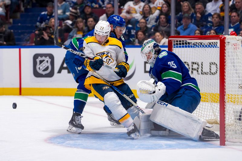 Apr 21, 2024; Vancouver, British Columbia, CAN; Vancouver Canucks goalie Thatcher Demko (35) watches as defenseman Nikita Zadorov (91) checks Nashville Predators forward Luke Evangelista (77) in the second period in game one of the first round of the 2024 Stanley Cup Playoffs at Rogers Arena. Mandatory Credit: Bob Frid-USA TODAY Sports