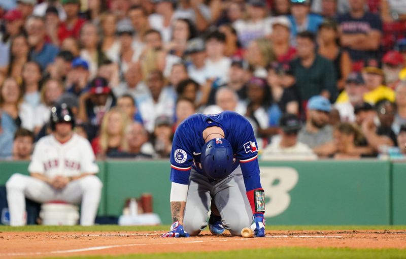 Aug 12, 2024; Boston, Massachusetts, USA; Texas Rangers catcher Jonah Heim (28) is hit by a pitch against the Boston Red Sox in the third inning at Fenway Park. Mandatory Credit: David Butler II-USA TODAY Sports