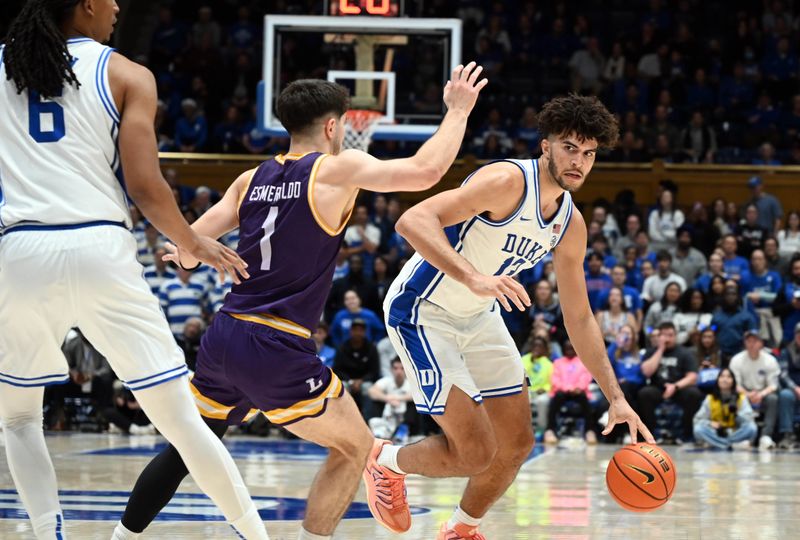 Dec 16, 2025; Durham, North Carolina, USA;  Duke Blue Devils forward Cameron Boozer (12) controls the ball in front of Lipscomb Bisons guard Mateo Esmeraldo (1) during the second half at Cameron Indoor Stadium. The Blue Devils won 97-73.  Mandatory Credit: Rob Kinnan-Imagn Images