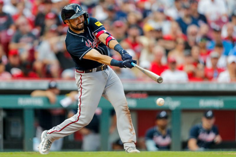 Jun 24, 2023; Cincinnati, Ohio, USA; Atlanta Braves catcher Travis d'Arnaud (16) hits a single against the Cincinnati Reds in the ninth inning at Great American Ball Park. Mandatory Credit: Katie Stratman-USA TODAY Sports