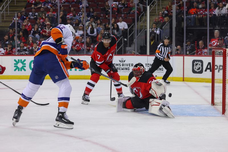 Oct 25, 2024; Newark, New Jersey, USA; New York Islanders left wing Anders Lee (27) scores a goal on New Jersey Devils goaltender Jake Allen (34) during the first period at Prudential Center. Mandatory Credit: Ed Mulholland-Imagn Images