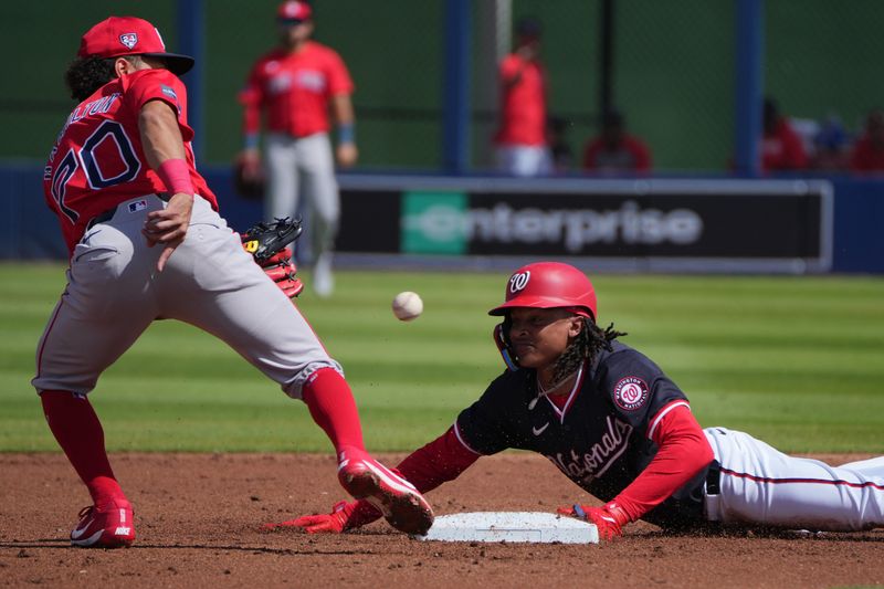 Feb 28, 2024; West Palm Beach, Florida, USA;  Washington Nationals infielder CJ Abrams steals second base as Boston Red Sox shortstop David Hamilton (70) covers on the play in the first inning at The Ballpark of the Palm Beaches. Mandatory Credit: Jim Rassol-USA TODAY Sports