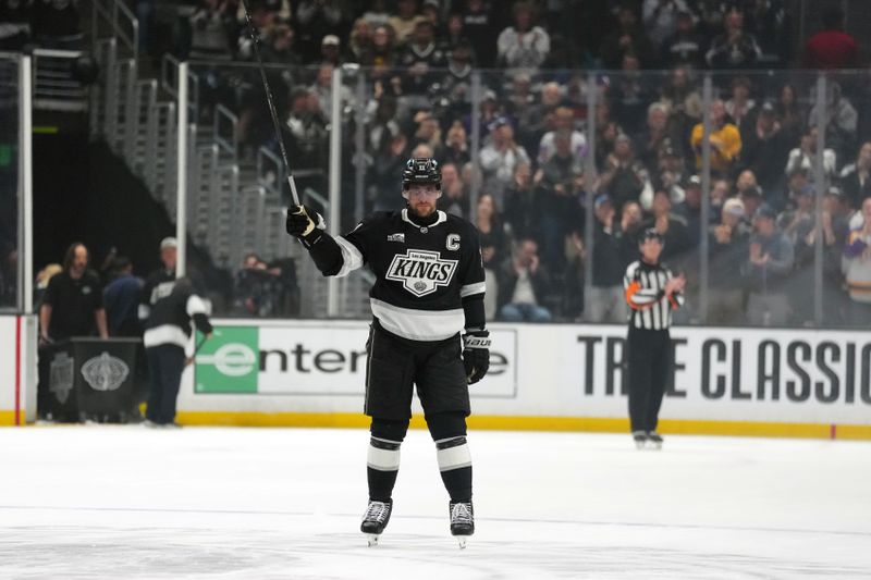 Mar 5, 2026; Los Angeles, California, USA; LA Kings center Alex Turcotte (15) is recognized for playing in his 1,500th career game in the first period against the New York Islanders at Crypto.com Arena. Mandatory Credit: Kirby Lee-Imagn Images