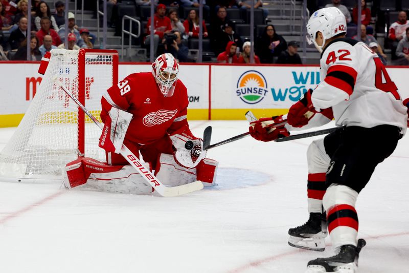 Oct 24, 2024; Detroit, Michigan, USA;  Detroit Red Wings goaltender Cam Talbot (39) makes a save on New Jersey Devils center Curtis Lazar (42) in the first period at Little Caesars Arena. Mandatory Credit: Rick Osentoski-Imagn Images