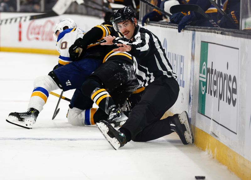 Nov 16, 2024; Boston, Massachusetts, USA; Linesman Jesse Marquis (86) makes an on sides call from his knee as two players get tangled up behind him during the second period of the game between the Boston Bruins and the St. Louis Blues at TD Garden. Mandatory Credit: Winslow Townson-Imagn Images