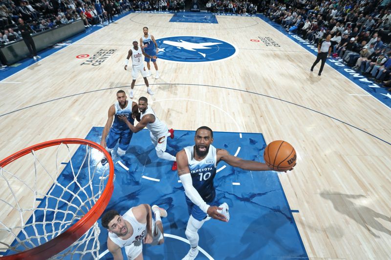 MINNEAPOLIS, MN -  MARCH 22: Mike Conley #10 of the Minnesota Timberwolves drives to the basket during the game against the Cleveland Cavaliers on March 22, 2024 at Target Center in Minneapolis, Minnesota. NOTE TO USER: User expressly acknowledges and agrees that, by downloading and or using this Photograph, user is consenting to the terms and conditions of the Getty Images License Agreement. Mandatory Copyright Notice: Copyright 2024 NBAE (Photo by David Sherman/NBAE via Getty Images)