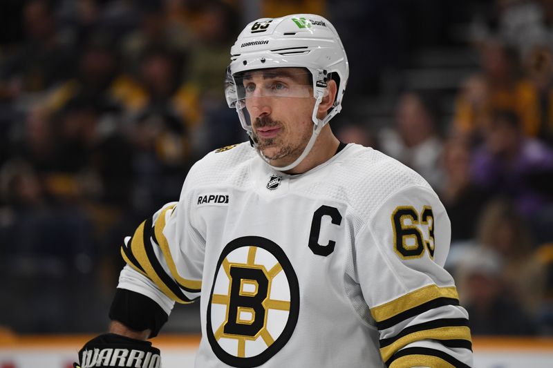 Apr 2, 2024; Nashville, Tennessee, USA; Boston Bruins left wing Brad Marchand (63) waits for a face off during the second period against the Nashville Predators at Bridgestone Arena. Mandatory Credit: Christopher Hanewinckel-USA TODAY Sports