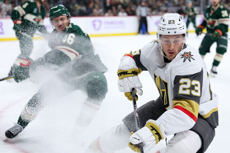 Nov 16, 2025; Saint Paul, Minnesota, USA; Vegas Golden Knights left wing Cole Reinhardt (23) and Minnesota Wild defenseman Jared Spurgeon (46) compete for the puck during the third period at Grand Casino Arena. Mandatory Credit: Matt Krohn-Imagn Images