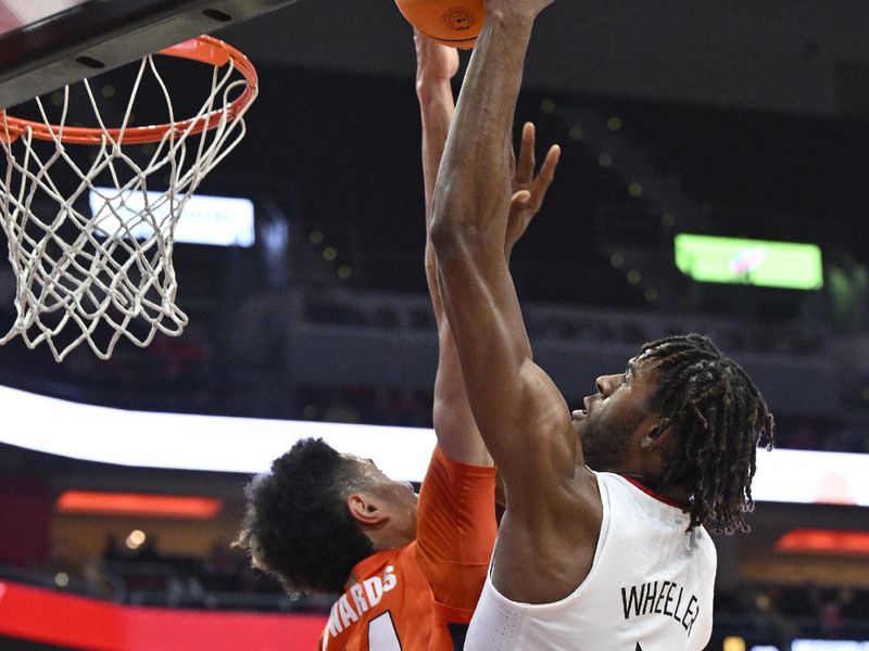 Jan 3, 2023; Louisville, Kentucky, USA;  Louisville Cardinals forward Roosevelt Wheeler (4) shoots against Syracuse Orange center Jesse Edwards (14) during the second half at KFC Yum! Center. Syracuse defeated Louisville 70-69. Mandatory Credit: Jamie Rhodes-USA TODAY Sports