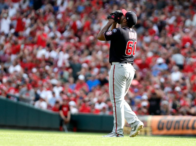 Aug 5, 2023; Cincinnati, Ohio, USA; Washington Nationals starting pitcher Joan Adon (60) reacts after giving up a hit to Cincinnati Reds catcher Luke Maile (not pictured) during the sixth inning at Great American Ball Park. Mandatory Credit: David Kohl-USA TODAY Sports