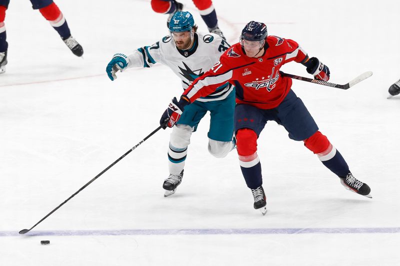 Dec 3, 2024; Washington, District of Columbia, USA; Washington Capitals center Aliaksei Protas (21) and San Jose Sharks defenseman Timothy Liljegren (37) battle for the puck in the first period at Capital One Arena. Mandatory Credit: Geoff Burke-Imagn Images