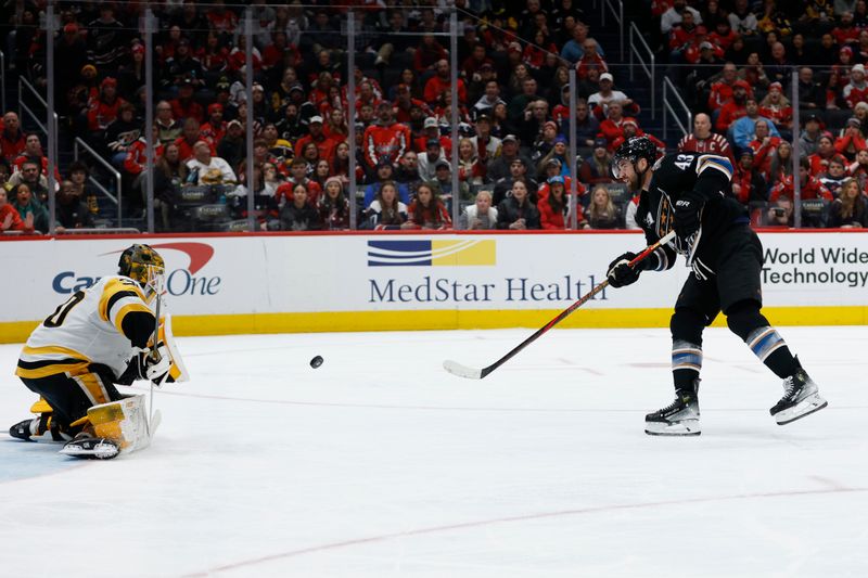 Jan 18, 2025; Washington, District of Columbia, USA; Washington Capitals right wing Tom Wilson (43) shoots the puck on Pittsburgh Penguins goaltender Joel Blomqvist (30) in the third period at Capital One Arena. Mandatory Credit: Geoff Burke-Imagn Images