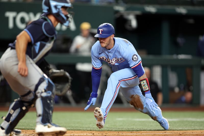 Apr 6, 2025; Arlington, Texas, USA; Texas Rangers catcher Jonah Heim (28) scores a run in the seventh inning against the Tampa Bay Rays at Globe Life Field. Mandatory Credit: Tim Heitman-Imagn Images