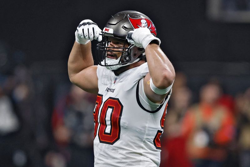 Tampa Bay Buccaneers defensive end Logan Hall (90) reacts after sacking Atlanta Falcons quarterback Kirk Cousins during the first half of an NFL football game Thursday, Oct. 3, 2024, in Atlanta. (AP Photo/Butch Dill)