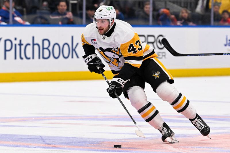 Apr 17, 2024; Elmont, New York, USA; Pittsburgh Penguins center Jansen Harkins (43) skates with the puck against the New York Islanders during the first period at UBS Arena. Mandatory Credit: Dennis Schneidler-USA TODAY Sports