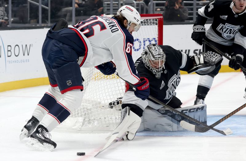 Nov 9, 2024; Los Angeles, California, USA; Los Angeles Kings goaltender David Rittich (31) poke checks the puck from Columbus Blue Jackets right wing Kirill Marchenko (86) during the first period at Crypto.com Arena. Mandatory Credit: Jason Parkhurst-Imagn Images