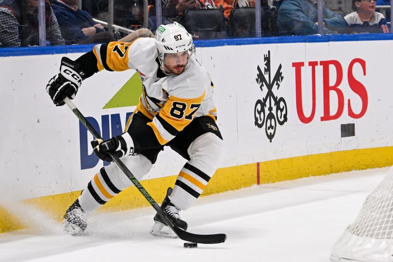 Apr 17, 2024; Elmont, New York, USA;  Pittsburgh Penguins center Sidney Crosby (87) controls the puck behind the net against the New York Islanders during the first period at UBS Arena. Mandatory Credit: Dennis Schneidler-USA TODAY Sports