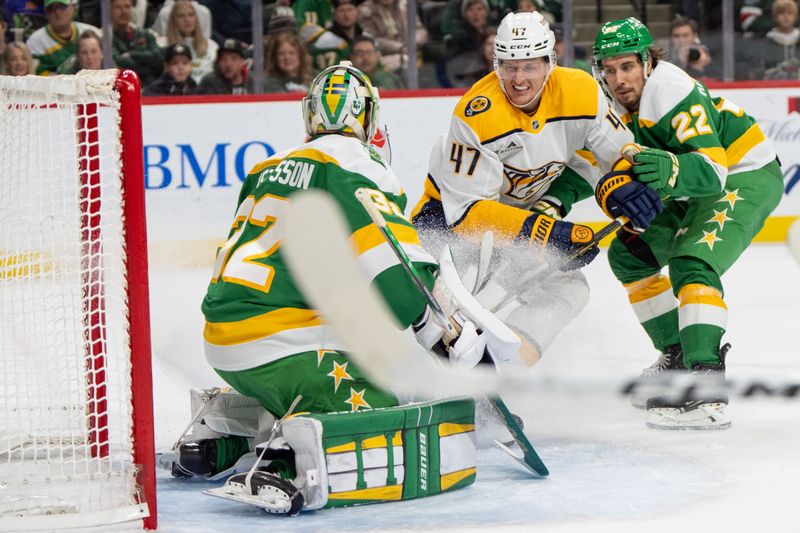 Dec 31, 2024; Saint Paul, Minnesota, USA; Nashville Predators right wing Michael McCarron (47) tries to tip a pass by Minnesota Wild goaltender Filip Gustavsson (32) with Minnesota Wild center Marat Khusnutdinov (22) defending in the first period at Xcel Energy Center. Mandatory Credit: Matt Blewett-Imagn Images