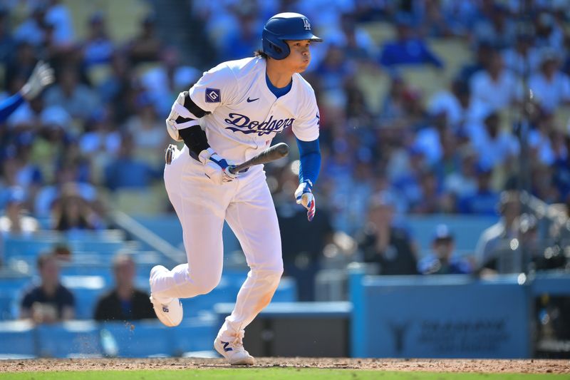 May 19, 2024; Los Angeles, California, USA; Los Angeles Dodgers designated hitter Shohei Ohtani (17) hits a walk off RBI single against the Cincinnati Reds during the tenth inning at Dodger Stadium. Mandatory Credit: Gary A. Vasquez-USA TODAY Sports