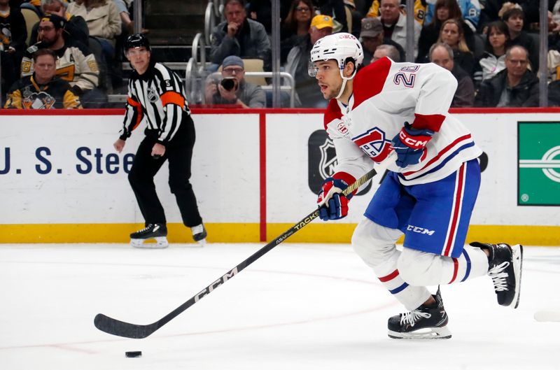 Jan 27, 2024; Pittsburgh, Pennsylvania, USA;  Montreal Canadiens defenseman Johnathan Kovacevic (26) skates with the puck against the Pittsburgh Penguins during the third period at PPG Paints Arena. The Penguins won 3-2 in overtime. Mandatory Credit: Charles LeClaire-USA TODAY Sports