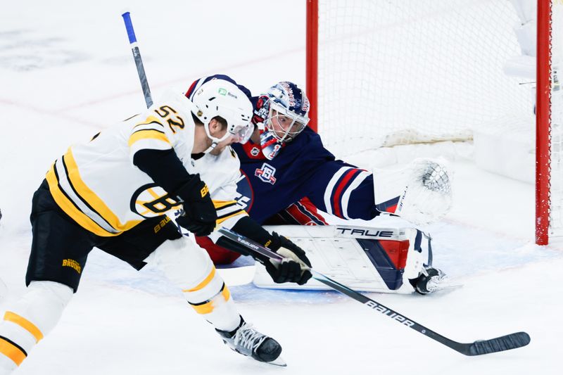 Dec 11, 2025; Winnipeg, Manitoba, CAN;  Boston Bruins forward Sean Kuraly (52) scores on Winnipeg Jets goalie Eric Comrie (1) during the first period at Canada Life Centre. Mandatory Credit: Terrence Lee-Imagn Images