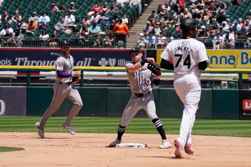 Jun 30, 2024; Chicago, Illinois, USA; Chicago White Sox designated hitter Eloy Jiménez (74) is forced out at second base as Colorado Rockies second baseman Aaron Schunk (30) throws to first base to complete a double play during the third inning at Guaranteed Rate Field. Mandatory Credit: David Banks-USA TODAY Sports