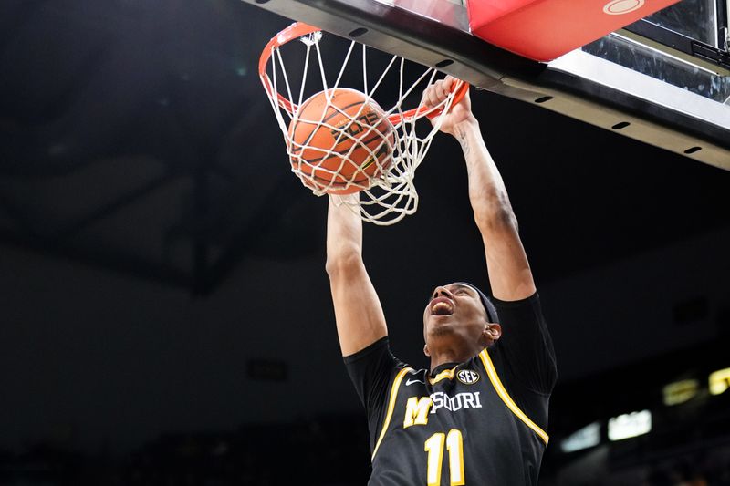 Jan 14, 2026; Columbia, Missouri, USA; Missouri Tigers guard Trent Pierce (11) dunks the ball against the Auburn Tigers during the first half of the game at Mizzou Arena. Mandatory Credit: Denny Medley-Imagn Images