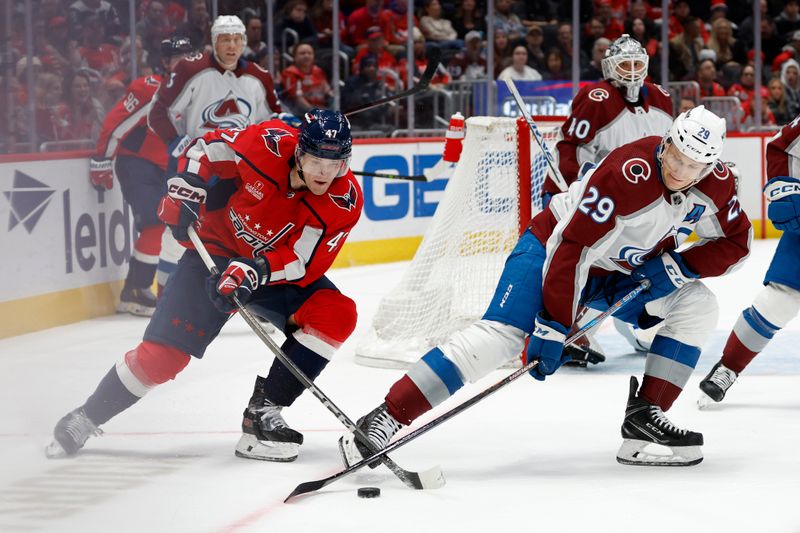 Feb 13, 2024; Washington, District of Columbia, USA; Colorado Avalanche center Nathan MacKinnon (29) and Washington Capitals left wing Beck Malenstyn (47) battles for the puck in the third period at Capital One Arena. Mandatory Credit: Geoff Burke-USA TODAY Sports