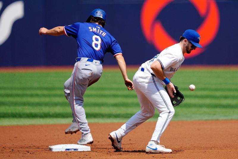 Jul 28, 2024; Toronto, Ontario, CAN; Texas Rangers third baseman Josh Smith (8) steals second base as Toronto Blue Jays second baseman Spencer Horwitz (48) bobbles a ball thrown by catcher Alejandro Kirk (not pictured) during the first inning at Rogers Centre. Mandatory Credit: John E. Sokolowski-USA TODAY Sports