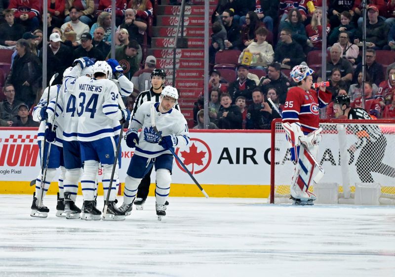 Apr 6, 2024; Montreal, Quebec, CAN; Toronto Maple Leafs forward Max Domi (11) celebrates with teammates after scoring a goal against Montreal Canadiens goalie Sam Montembeault (35)  during the second period at the Bell Centre. Mandatory Credit: Eric Bolte-USA TODAY Sports