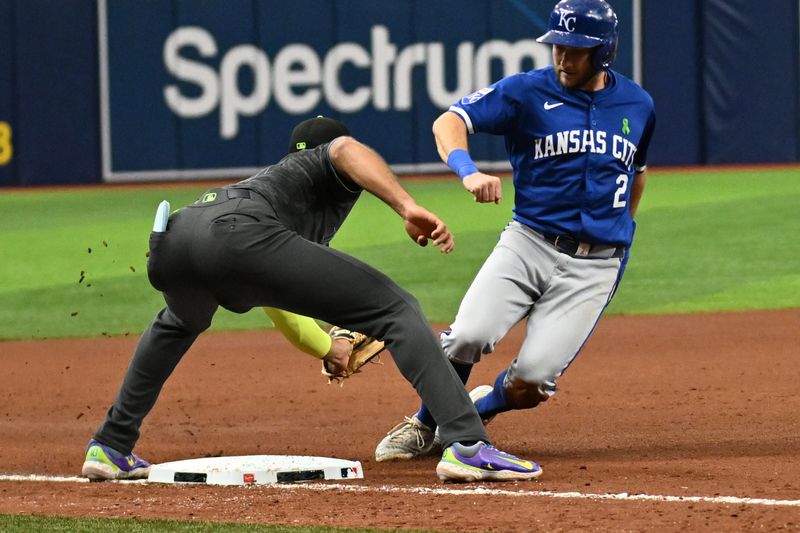 May 25, 2024; St. Petersburg, Florida, USA; Kansas City Royals center fielder Garrett Hampson (2) gets tagged out by Tampa Bay Rays third baseman Amed Rosario (10) in the seventh inning at Tropicana Field. Mandatory Credit: Jonathan Dyer-USA TODAY Sports
