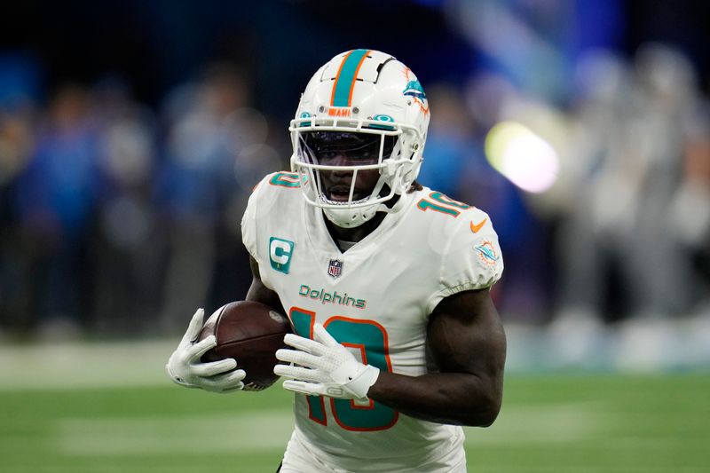 Miami Dolphins wide receiver Tyreek Hill runs during pregame of an NFL football game against the Detroit Lions, Sunday, Oct. 30, 2022, in Detroit. (AP Photo/Paul Sancya)