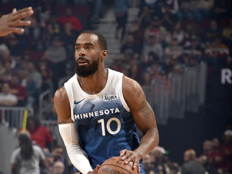 CLEVELAND, OH - MARCH 8: Mike Conley #10 of the Minnesota Timberwolves handles the ball during the game against the Cleveland Cavaliers on March 8, 2024 at Rocket Mortgage FieldHouse in Cleveland, Ohio. NOTE TO USER: User expressly acknowledges and agrees that, by downloading and/or using this Photograph, user is consenting to the terms and conditions of the Getty Images License Agreement. Mandatory Copyright Notice: Copyright 2024 NBAE (Photo by David Liam Kyle/NBAE via Getty Images)