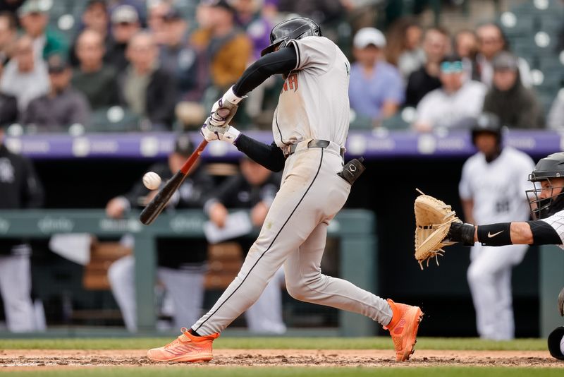 Apr 10, 2024; Denver, Colorado, USA; Arizona Diamondbacks shortstop Blaze Alexander (9) hits a single in the sixth inning against the Colorado Rockies at Coors Field. Mandatory Credit: Isaiah J. Downing-USA TODAY Sports