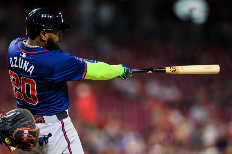Sep 18, 2024; Cincinnati, Ohio, USA; Atlanta Braves designated hitter Marcell Ozuna (20) hits a solo home run in the seventh inning against the Cincinnati Reds at Great American Ball Park. Mandatory Credit: Katie Stratman-Imagn Images