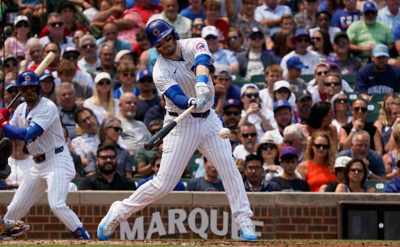 Jul 24, 2024; Chicago, Illinois, USA; Chicago Cubs outfielder Ian Happ (8) hits a one run single against the Milwaukee Brewers during the first inning at Wrigley Field. Mandatory Credit: David Banks-USA TODAY Sports