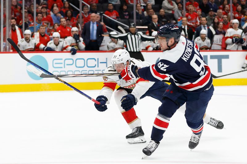 Nov 8, 2023; Washington, District of Columbia, USA; Washington Capitals center Evgeny Kuznetsov (92) shoots the puck as Florida Panthers defenseman Niko Mikkola (77) defends in the third period at Capital One Arena. Mandatory Credit: Geoff Burke-USA TODAY Sports