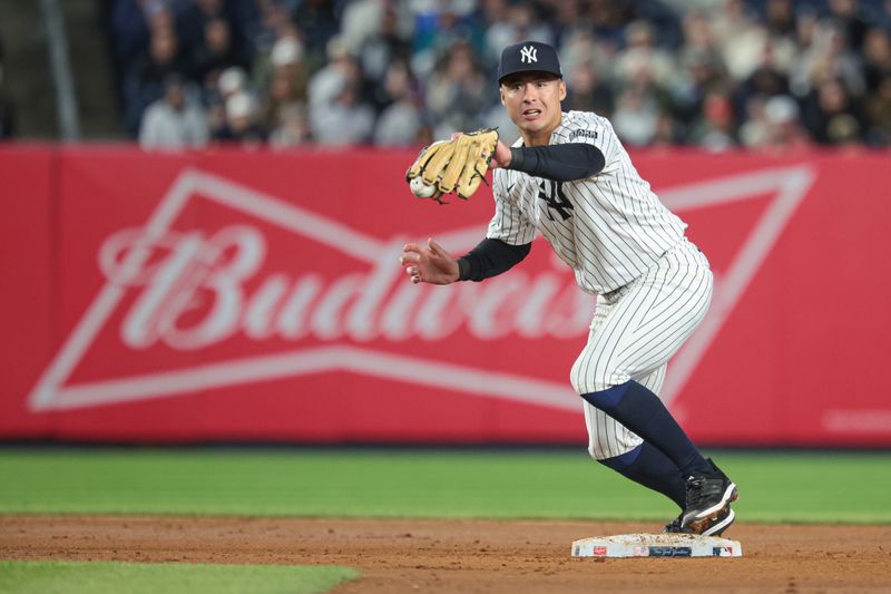 Apr 25, 2024; Bronx, New York, USA; New York Yankees shortstop Anthony Volpe (11) forces out Oakland Athletics left fielder Esteury Ruiz (not pictured) at second base during the eighth inning at Yankee Stadium. Mandatory Credit: Vincent Carchietta-USA TODAY Sports