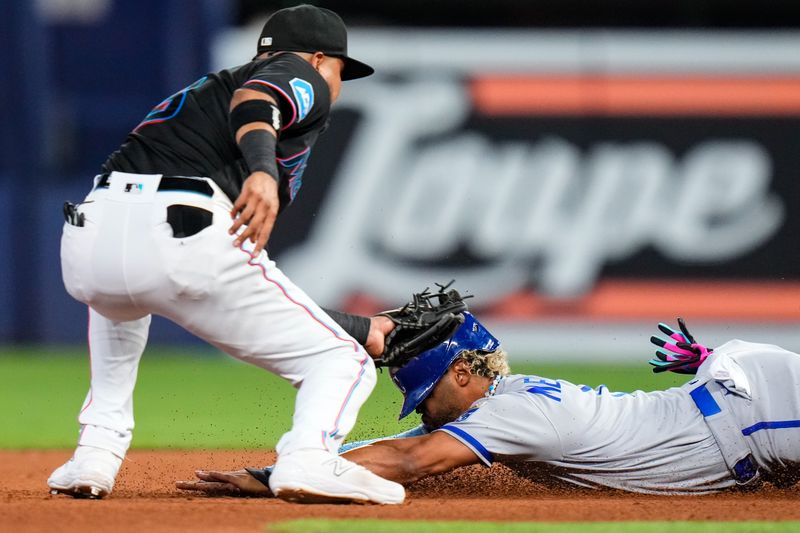 Jun 7, 2023; Miami, Florida, USA; Miami Marlins second baseman Luis Arraez (3) tags out Kansas City Royals right fielder MJ Melendez (1) during the fourth inning at loanDepot Park. Mandatory Credit: Rich Storry-USA TODAY Sports