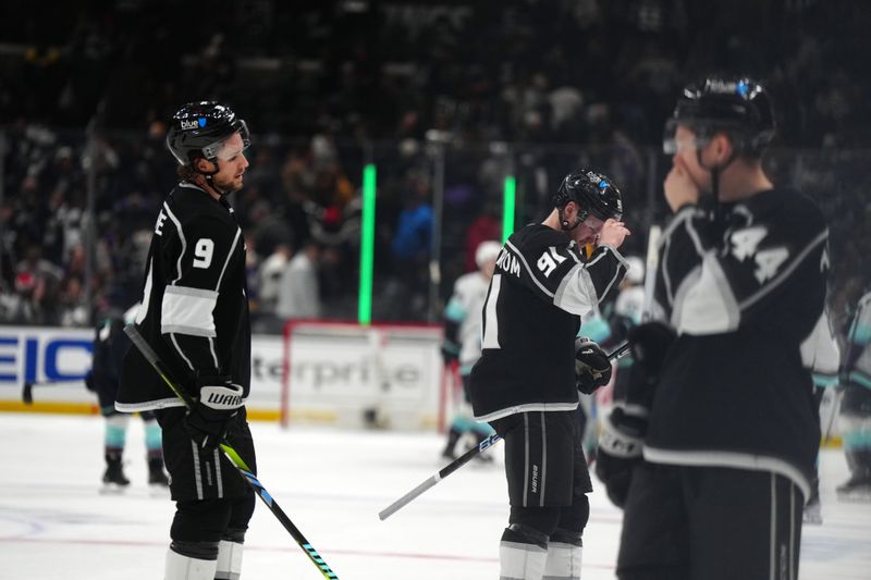 Dec 20, 2023; Los Angeles, California, USA; LA Kings right wing Adrian Kempe (9) and right wing Carl Grundstrom (91) react at the end of the game against the Seattle Kraken period at Crypto.com Arena. Mandatory Credit: Kirby Lee-USA TODAY Sports