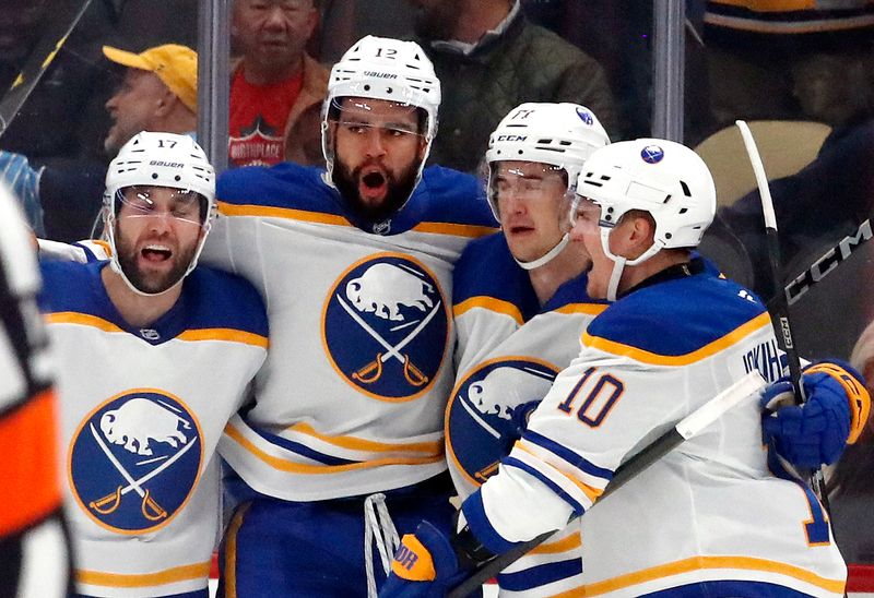 Oct 16, 2024; Pittsburgh, Pennsylvania, USA;  Buffalo Sabres left wing Jordan Greenway (LC) celebrates with teammates after scoring a goal against the Pittsburgh Penguins during the first period against at PPG Paints Arena. Mandatory Credit: Charles LeClaire-Imagn Images