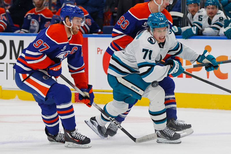 Jan 29, 2026; Edmonton, Alberta, CAN; Edmonton Oilers forward Connor McDavid (97) and San Jose Sharks forward Macklin Celebrini (71) look for a loose puck during the second period at Rogers Place. Mandatory Credit: Perry Nelson-Imagn Images
