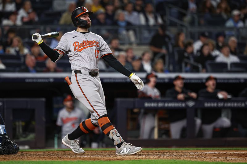 Sep 24, 2024; Bronx, New York, USA; Baltimore Orioles left fielder Colton Cowser (17) hits a solo home run during the eighth inning against the New York Yankees at Yankee Stadium. Mandatory Credit: Vincent Carchietta-Imagn Images