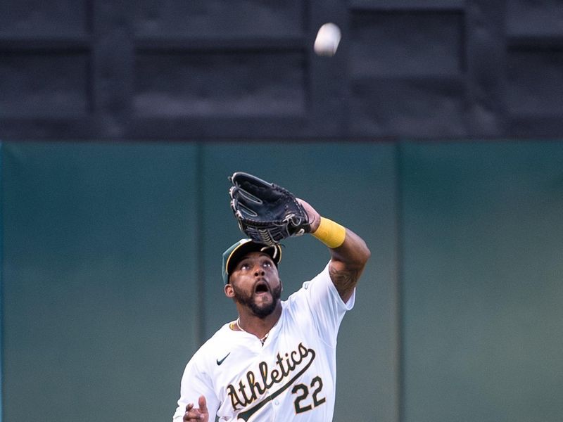 Jul 2, 2024; Oakland, California, USA; Oakland Athletics outfielder Miguel Andujar (22) makes a catch in left field during the fifth inning of the game against the Los Angeles Angels at Oakland-Alameda County Coliseum. Mandatory Credit: Ed Szczepanski-USA TODAY Sports