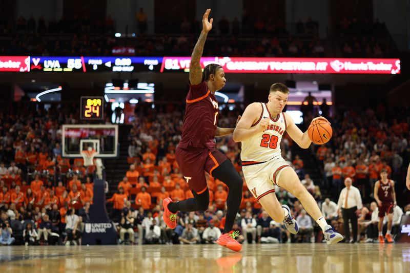 Mar 7, 2026; Charlottesville, Virginia, USA; Virginia Cavaliers forward Thijs de Ridder (28) drives to the basket as Virginia Tech Hokies forward Tobi Lawal (1) defends in the second half at John Paul Jones Arena. Mandatory Credit: Geoff Burke-Imagn Images