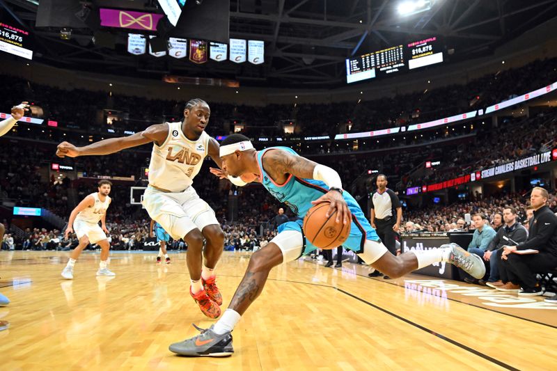 CLEVELAND, OHIO - JANUARY 04: Torrey Craig #0 of the Phoenix Suns drives to the basket around Caris LeVert #3 of the Cleveland Cavaliers at Rocket Mortgage Fieldhouse on January 04, 2023 in Cleveland, Ohio. The Cavaliers defeated 90-88. NOTE TO USER: User expressly acknowledges and agrees that, by downloading and or using this photograph, User is consenting to the terms and conditions of the Getty Images License Agreement. (Photo by Jason Miller/Getty Images)